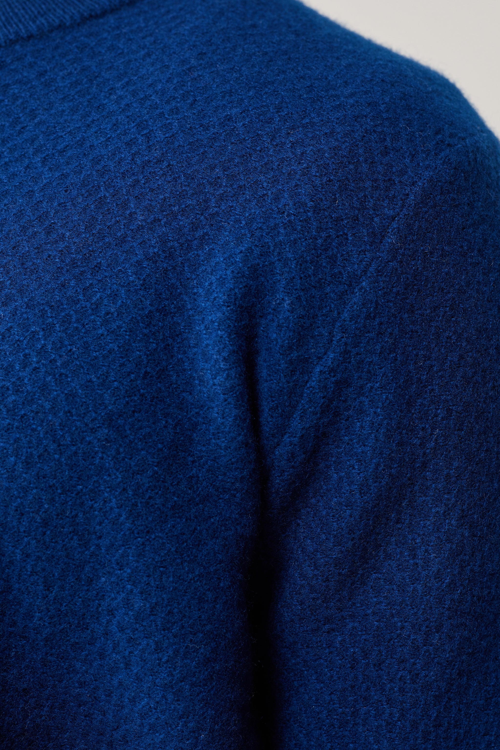 a close up of a person wearing a blue sweater