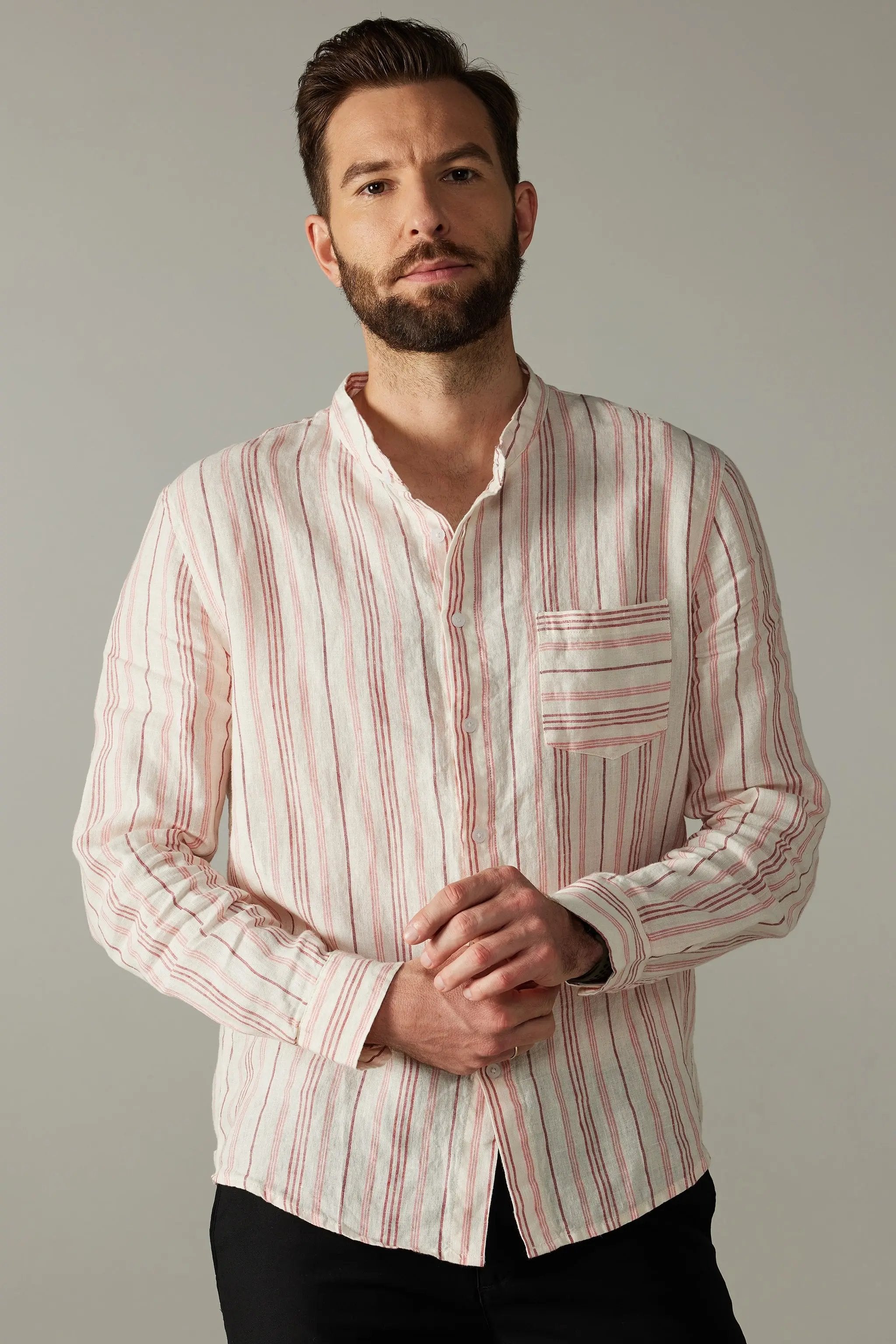 a man with a beard wearing a striped shirt
