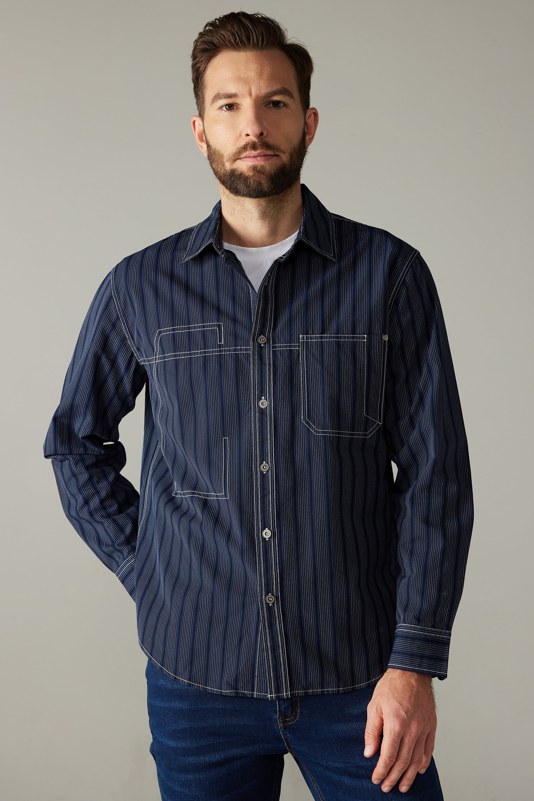 a man with a beard wearing a blue shirt