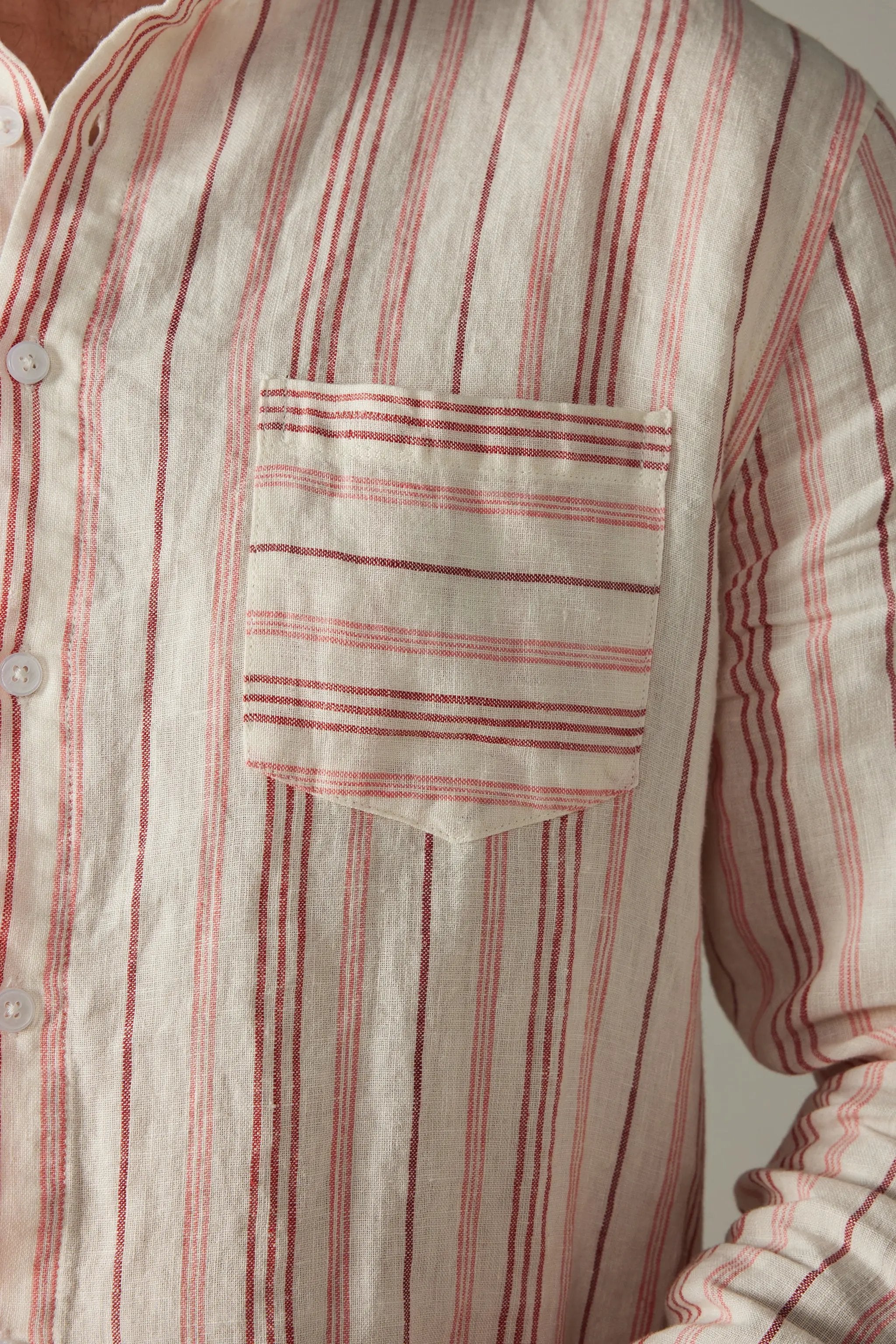 a man wearing a red and white striped shirt
