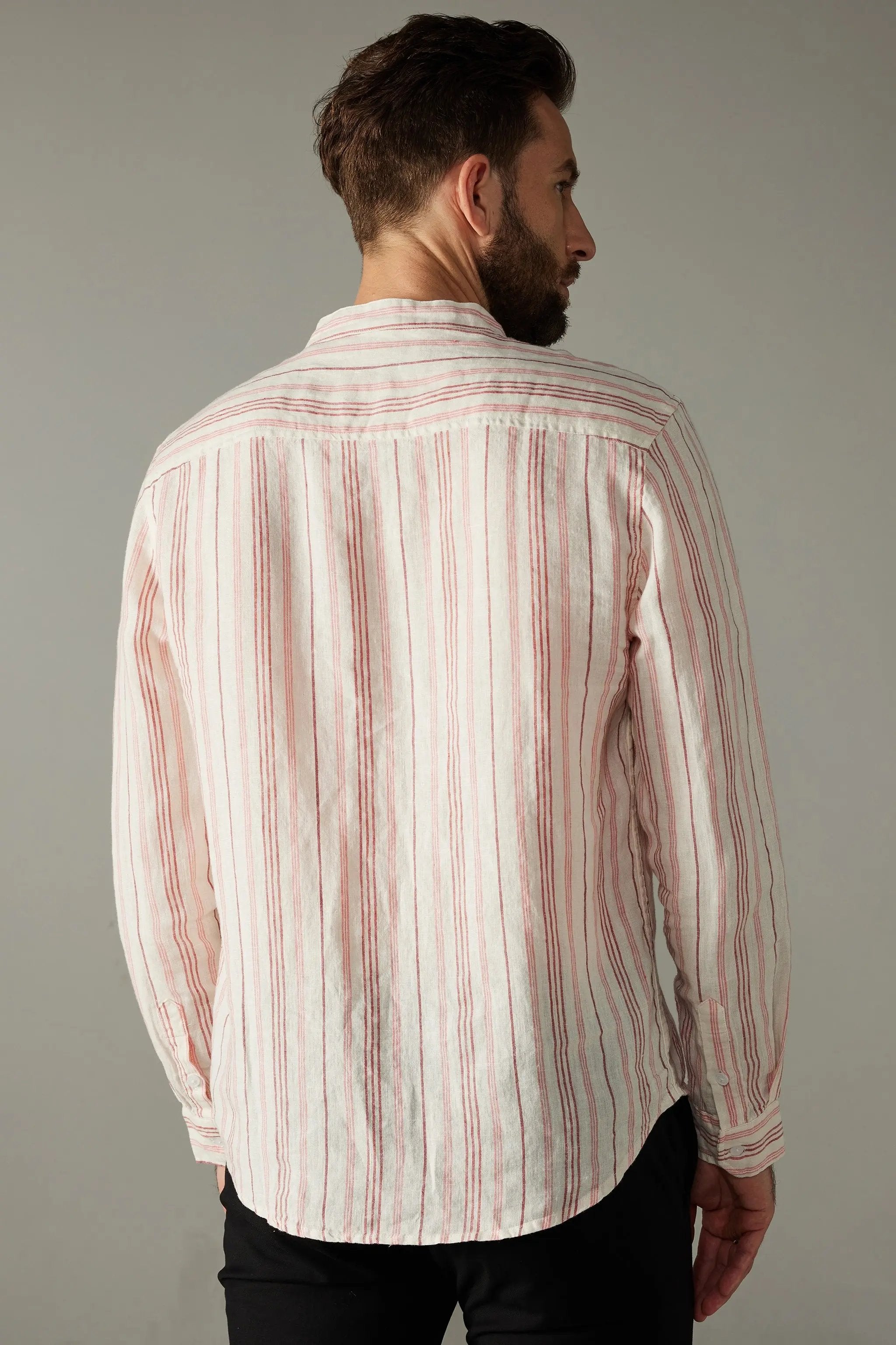a man with a beard wearing a red and white striped shirt