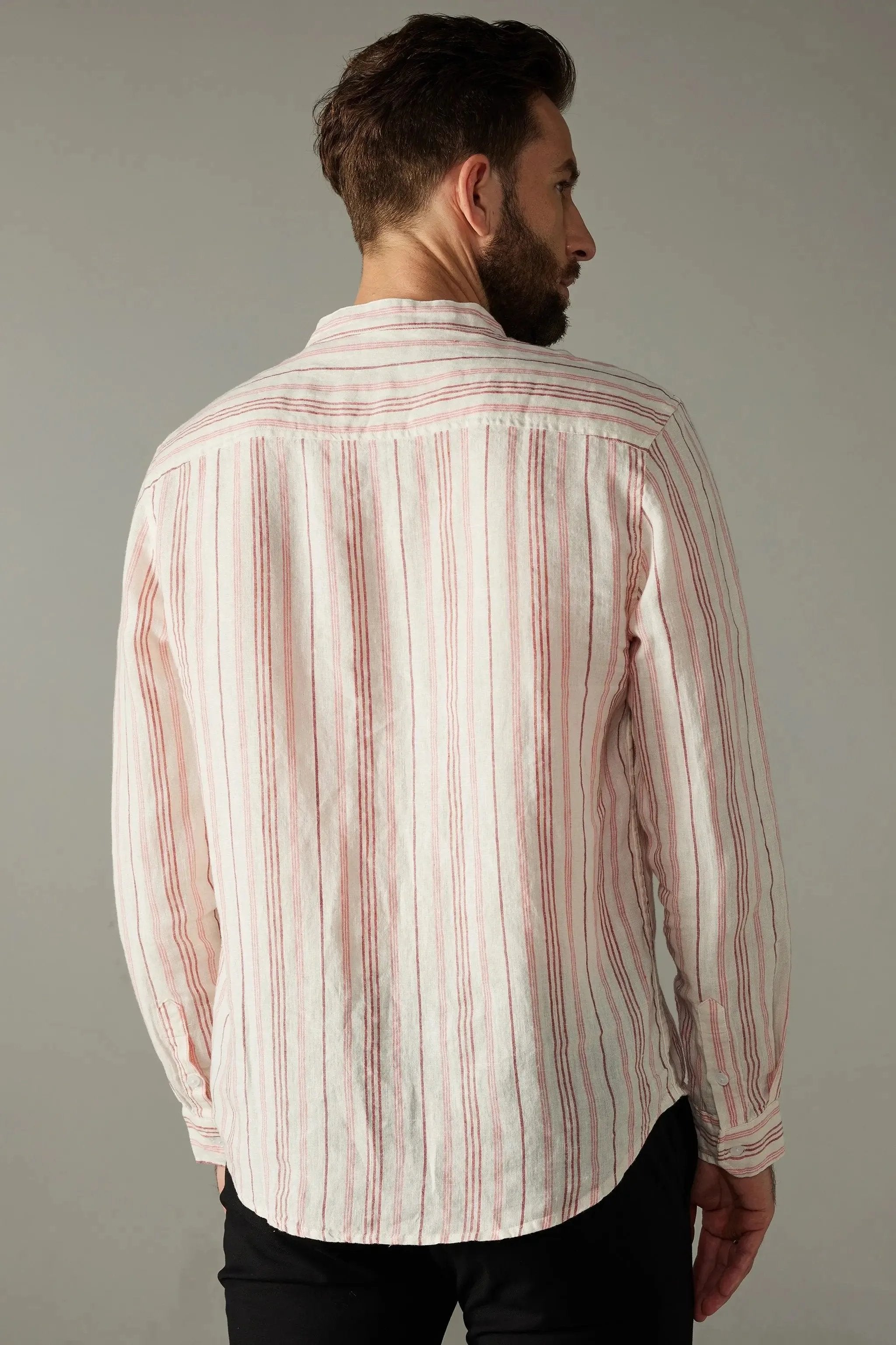 a man with a beard wearing a red and white striped shirt