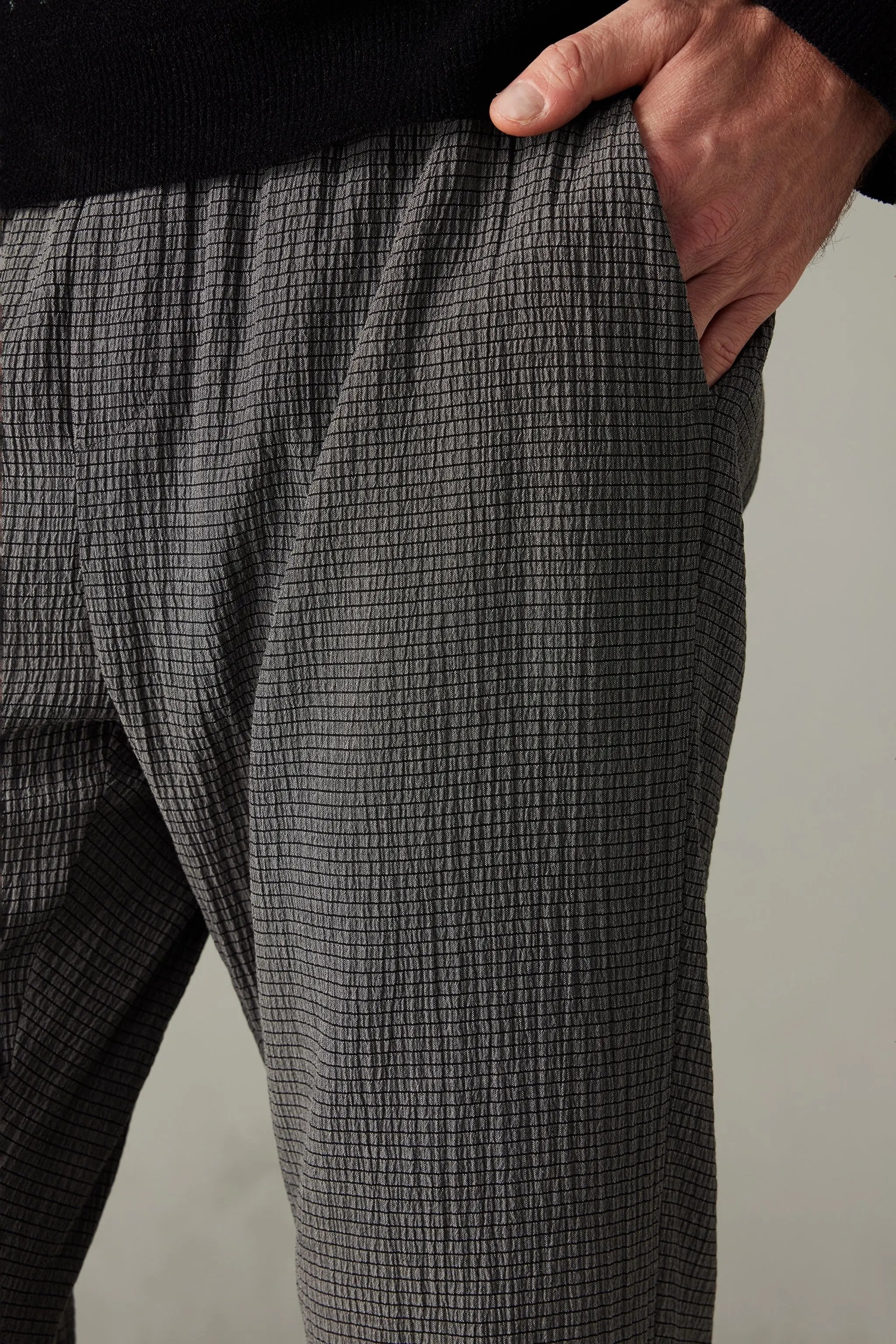 a close up of a person's pants with a black sweater on