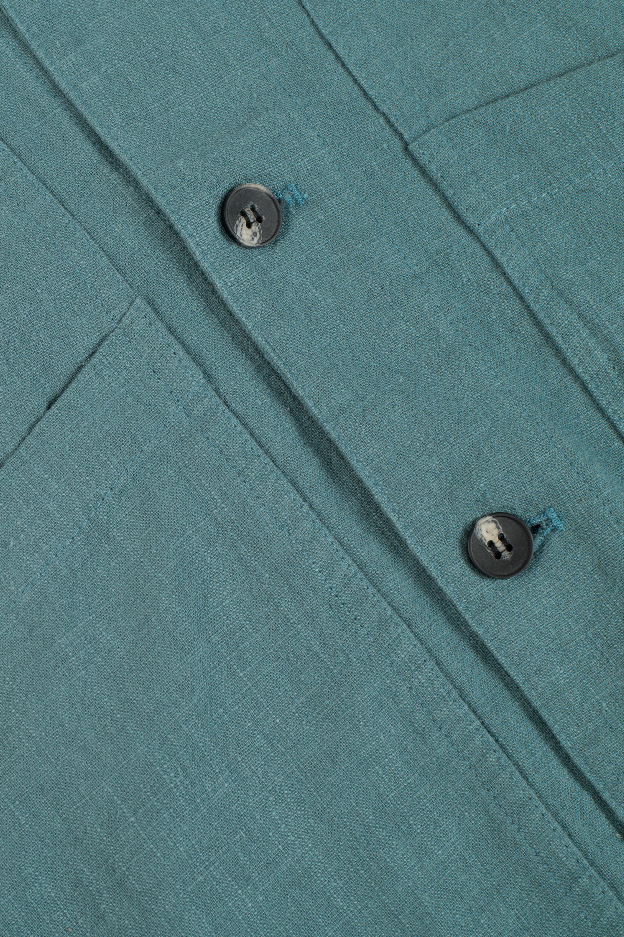 a green shirt with buttons on the chest