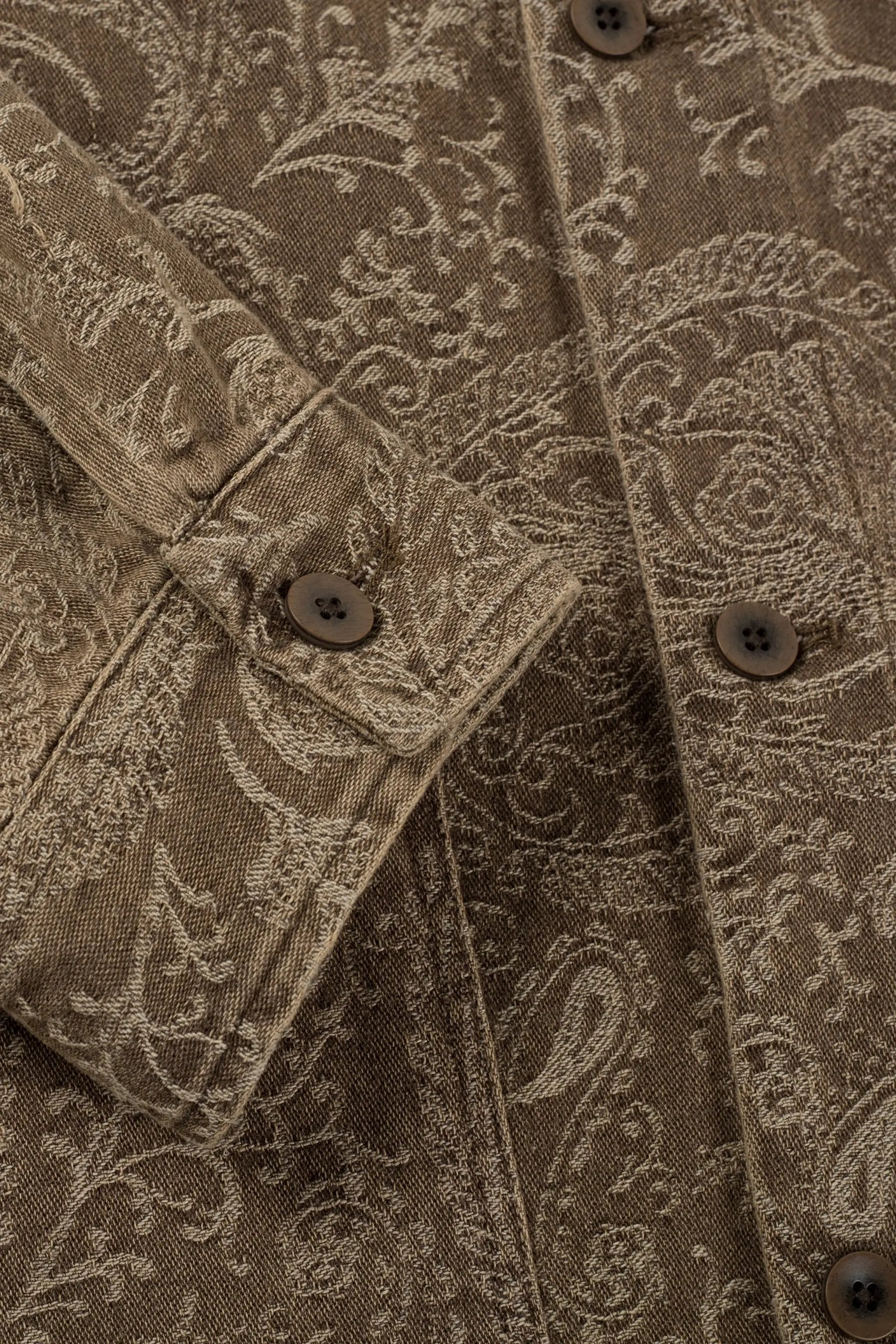 a close up of a shirt with a paisley pattern