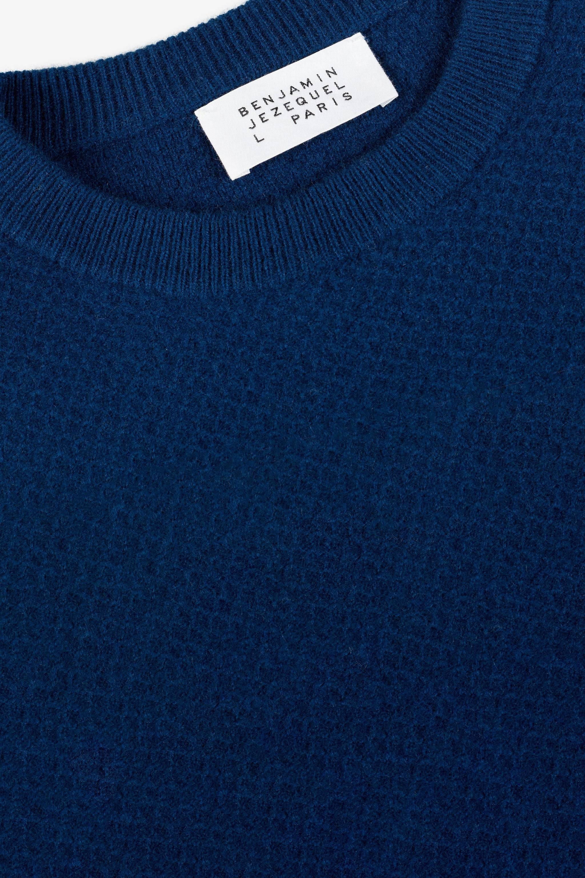 a blue sweater with a label on it