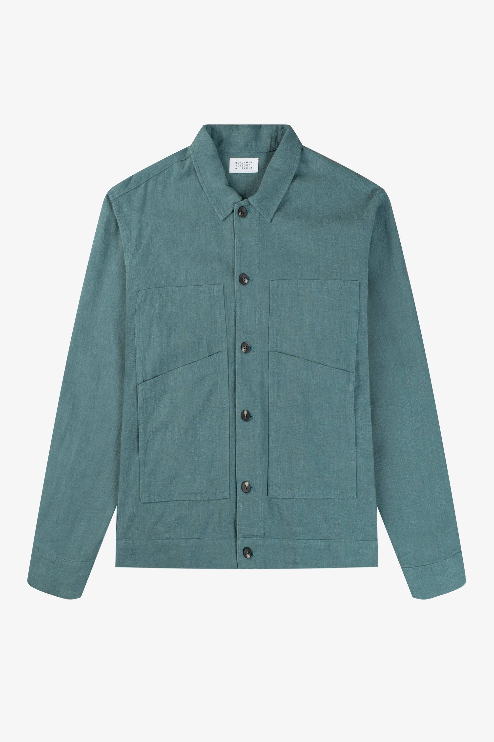 a green shirt with buttons on the chest
