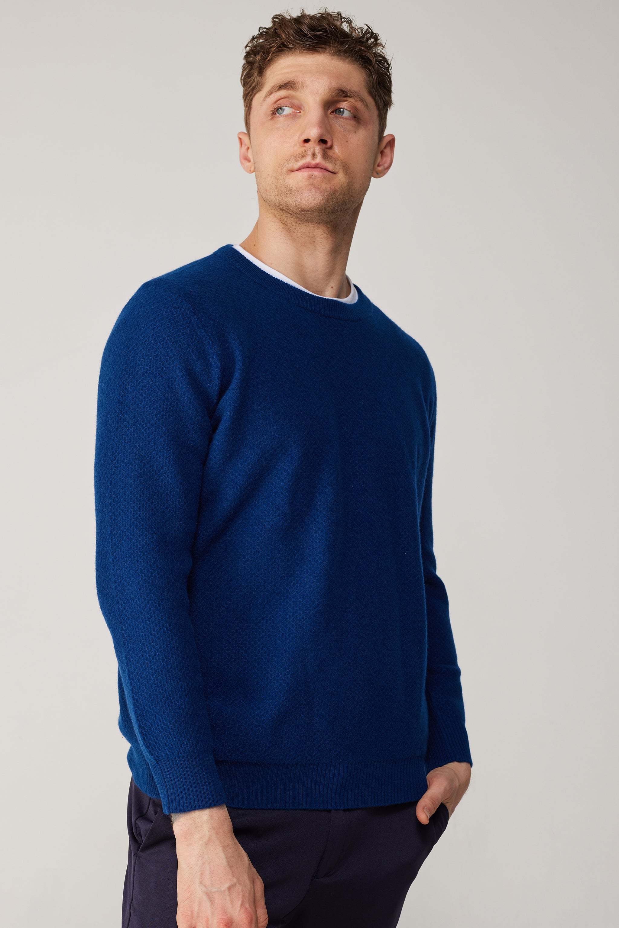 a blue sweater with a round neck and long sleeves